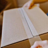 Foto eines Kartons, der zugeklebt wird.